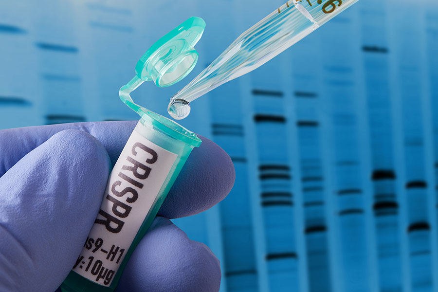 Hand hält Ampulle während Flüssigkeit hineintropft. Im Hintergrund eine grafisch dargestellte DNA. Hand hält Ampulle während Flüssigkeit hineintropft. Im Hintergrund eine grafisch dargestellte DNA.