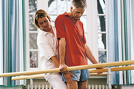 Physiotherapeutin übt mit Patienten Gangtraining